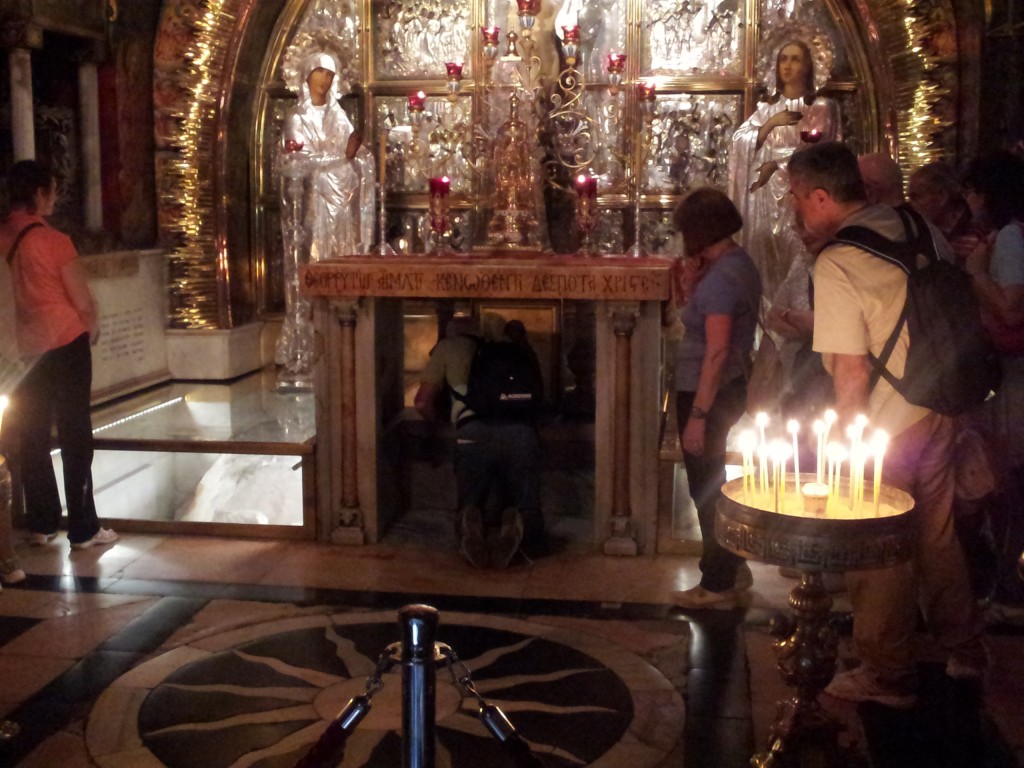 The Golgatha Altar, marking the traditional location where the cross was mounted on Calvary during the crucifixion. The stone encased in glass on the left is the "rock of Calvary," marking the 12th station of the cross. The altar is Greek Orthodox.