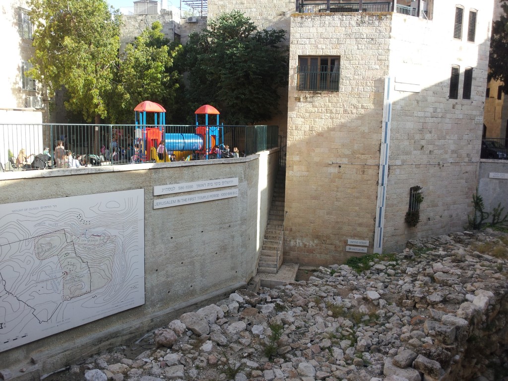 There are few places in Jerusalem where the literal word of the Bible and real modern life intersect in a clear fashion. This is one of them. Here is the remains of a demolished house (lower right), a thick wall (on the ground, and above it a playground in the Jewish Quarter teeming with energetic, happy children and their families. This place is mentioned in the Bible: "You counted the buildings in Jerusalem  and tore down houses to strengthen the wall. (Isaiah 22:10)" This location, archaeologically, is the one place so far found where the old defensive wall thickens to repel attack from the outside, at the cost of houses right next to where the wall was reinforced.