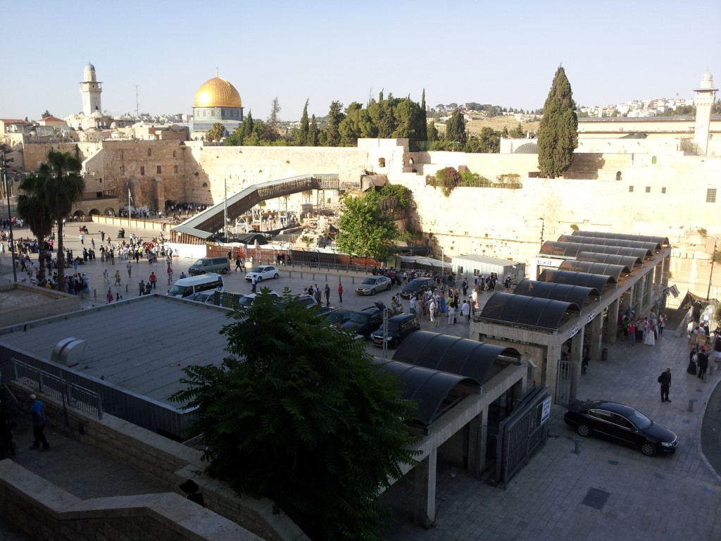 Looking down into the plaza in front of the Wailing Wall. We see the security checkpoint at the entrance. In the distance, we see the mosque atop the Temple Mount, just beyond the wall.