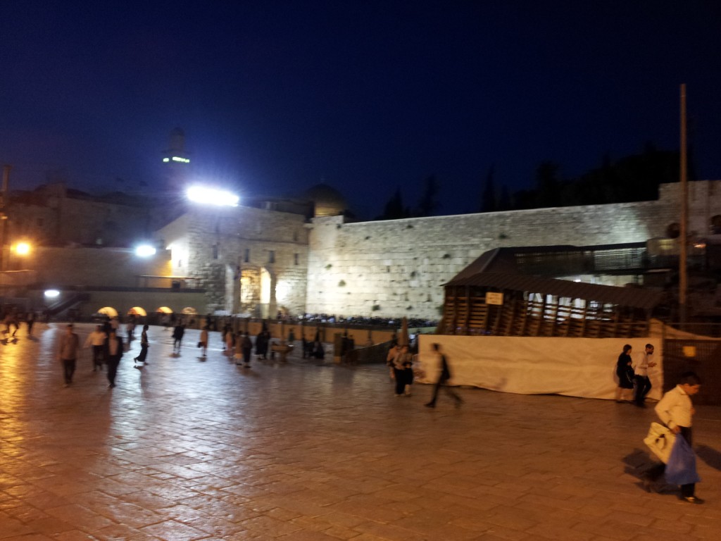 The plaza in front of the Wailing Wall at night. May more people have gathered to pray.