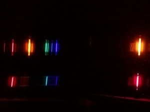 The atomic spectral lines of hydrogen (bottom) and helium (top). These elements are the most abundant in stars like our sun. This photo was taken in preparation for an exercise in Modern Physics where were build a "model star" and view the star through a diffraction grating to see what its spectrum would look like if we were at rest with respect to the star. Shifts in these spectral lines can be used to find the speed of the star, thanks to the theory of relativity.