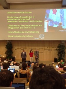 CMS Spokesperson Joseph Incandela (left), ATLAS Spokesperson Fabiola Gianotti (center), and CERN Director General Rolf Heuer (right) at the July 4, 2012 announcement of the discovery of a new subatomic particle. Photo by Stephen Sekula.