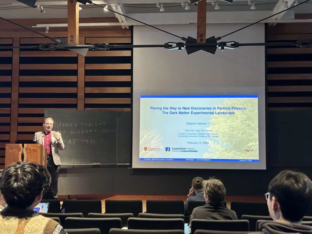 A speaker on stage giving a presentation to an audience.