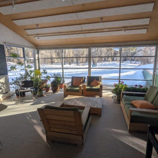 A common area at the Aspen Center for Physics, with musical instruments, blackboards, and plenty of casual seating options.