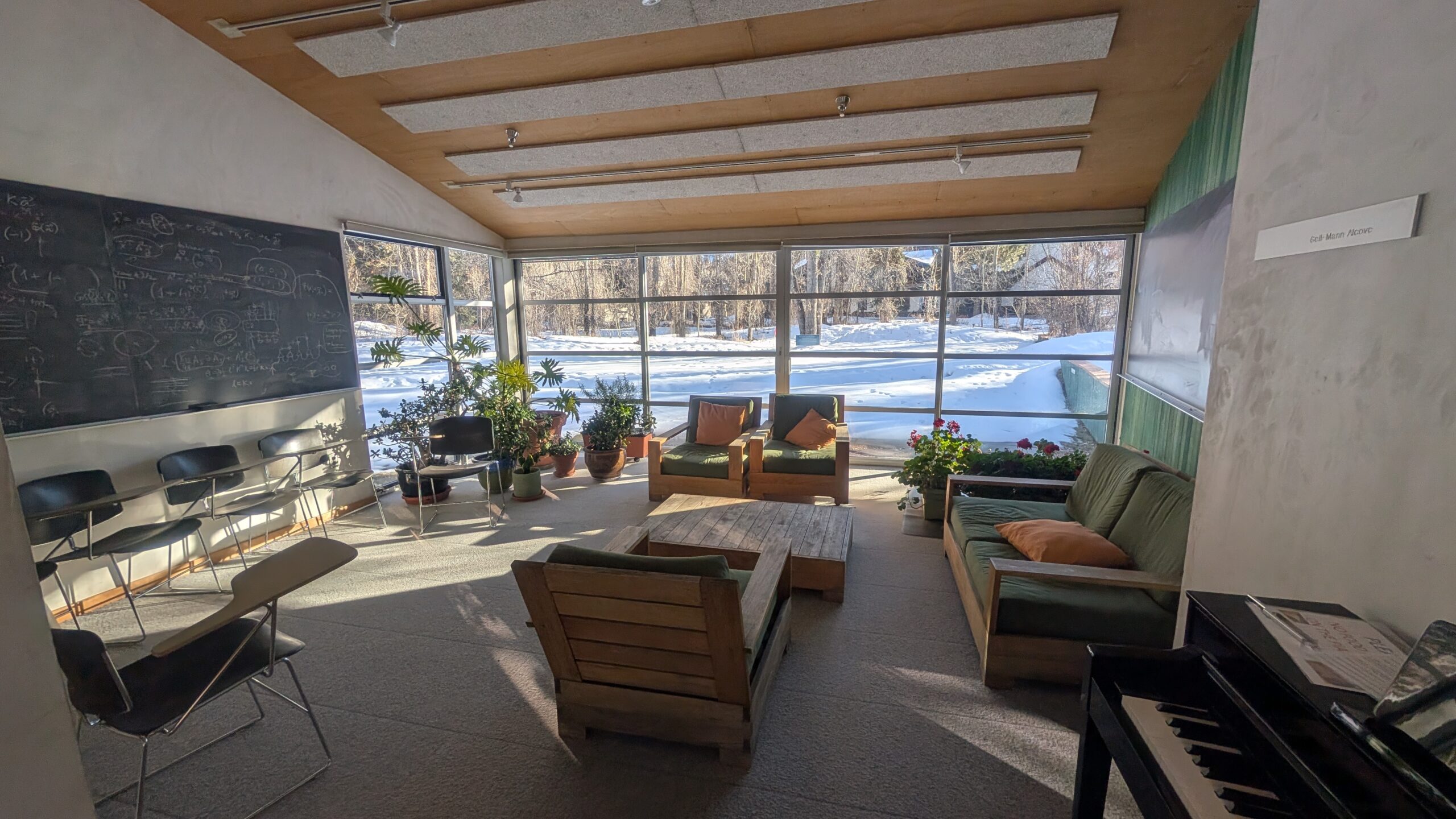 A common area at the Aspen Center for Physics, with musical instruments, blackboards, and plenty of casual seating options.