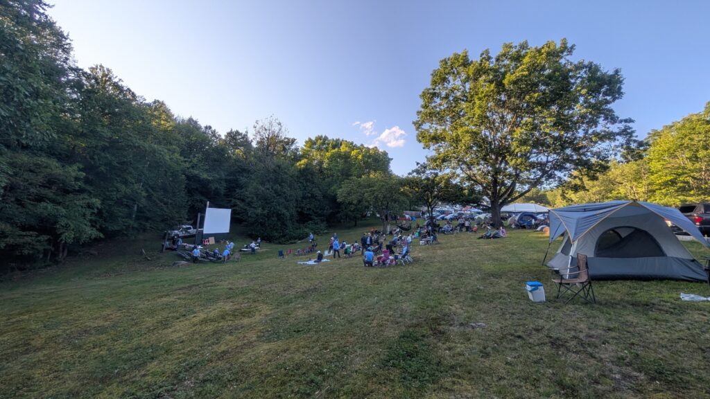 People begin to stake out places on the hill before the final program